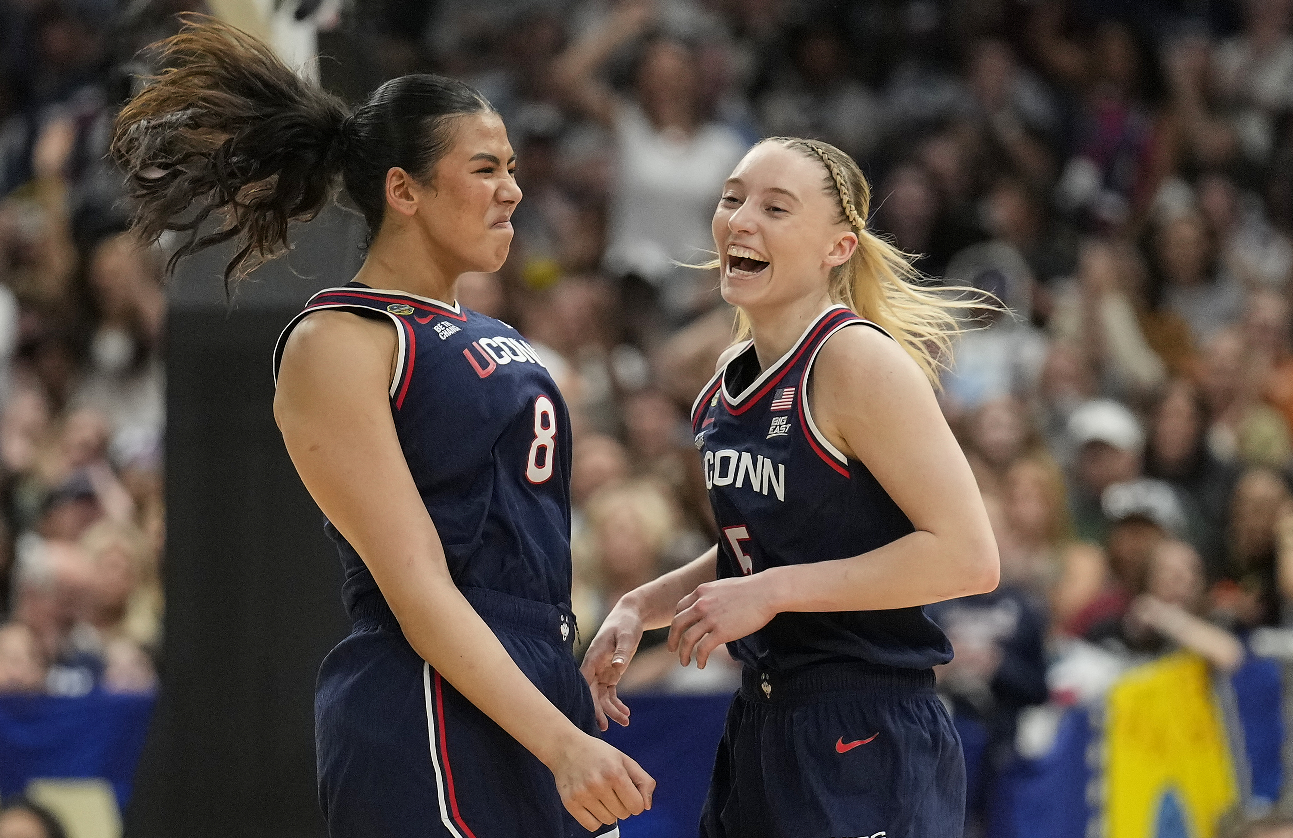 UConn center Jana El Alfy (8) and UConn guard Paige Bueckers (5) react during the first half of a national semifinal Final Four game against UCLA during the women's NCAA college basketball tournament, Friday, April 4, 2025, in Tampa, Fla.