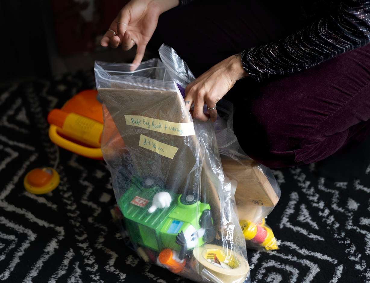 Children’s Service Society of Utah parent educator Kat Lora packs up the age-appropriate toys that she brought with her at the Williams Caro home in West Valley on April 3. Lora was visiting Gabriela Caro and her two young sons as part of the group's home visitation program.