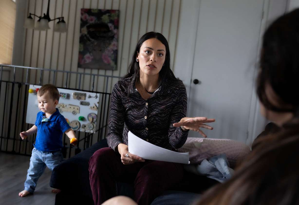 Children’s Service Society of Utah parent educator Kat Lora provides parenting information to Gabriela Caro at the Williams Caro home in West Valley on April 3. Lora was visiting the Williams Caro family as part of the home visitation program of the group.