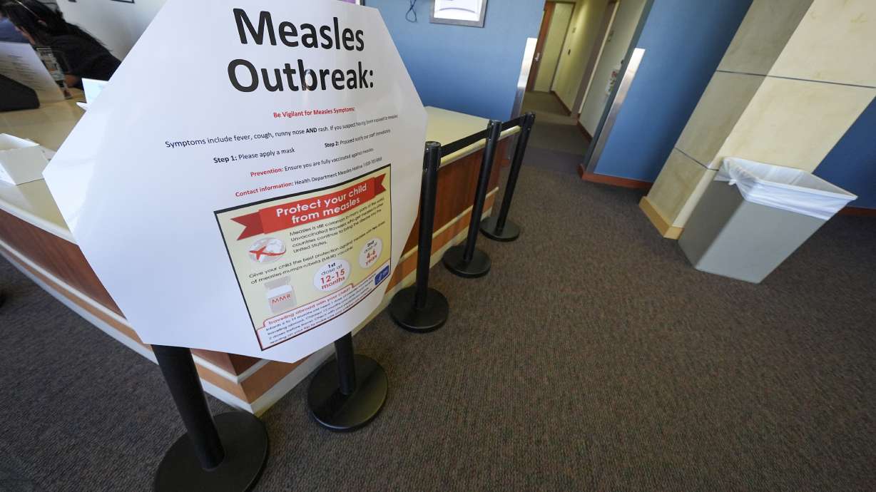 A measles sign is seen at the Texas Tech University Health Sciences Center, Feb. 25, in Lubbock, Texas. A second child has died from measles-related causes in West Texas.