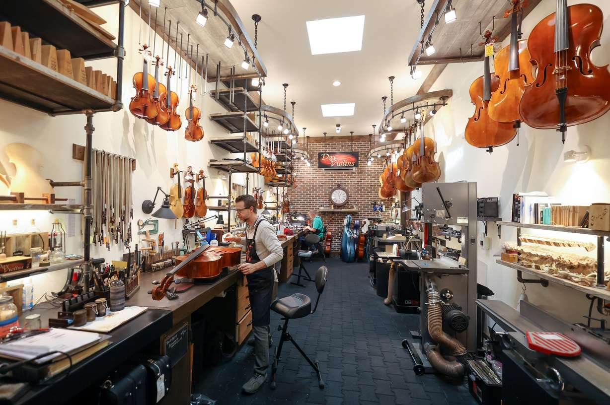 Adam Day, Day Violins owner, works on a cello at Day Violins in Murray on March 20.