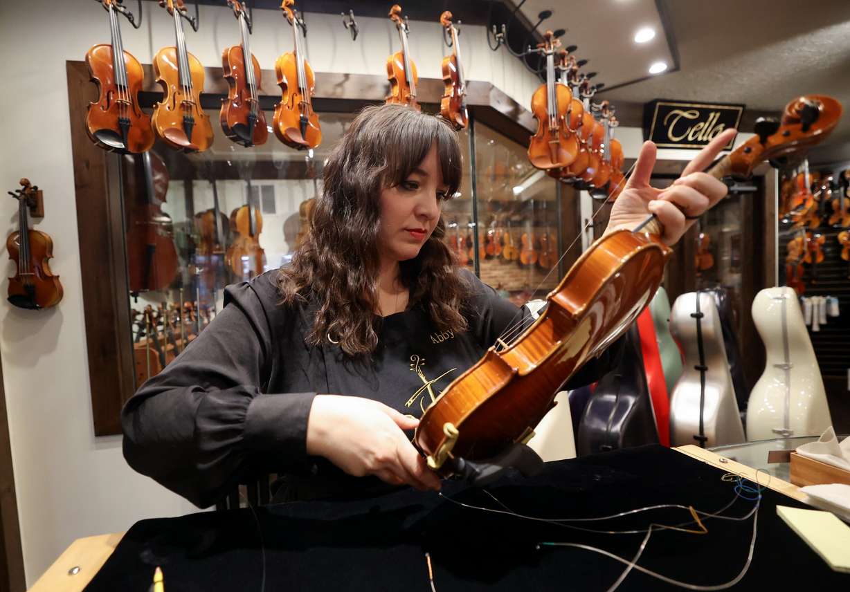 Abby Kagie, Day Violins sales floor manager, restrings a violin for a customer at Day Violins in Murray on March 20.