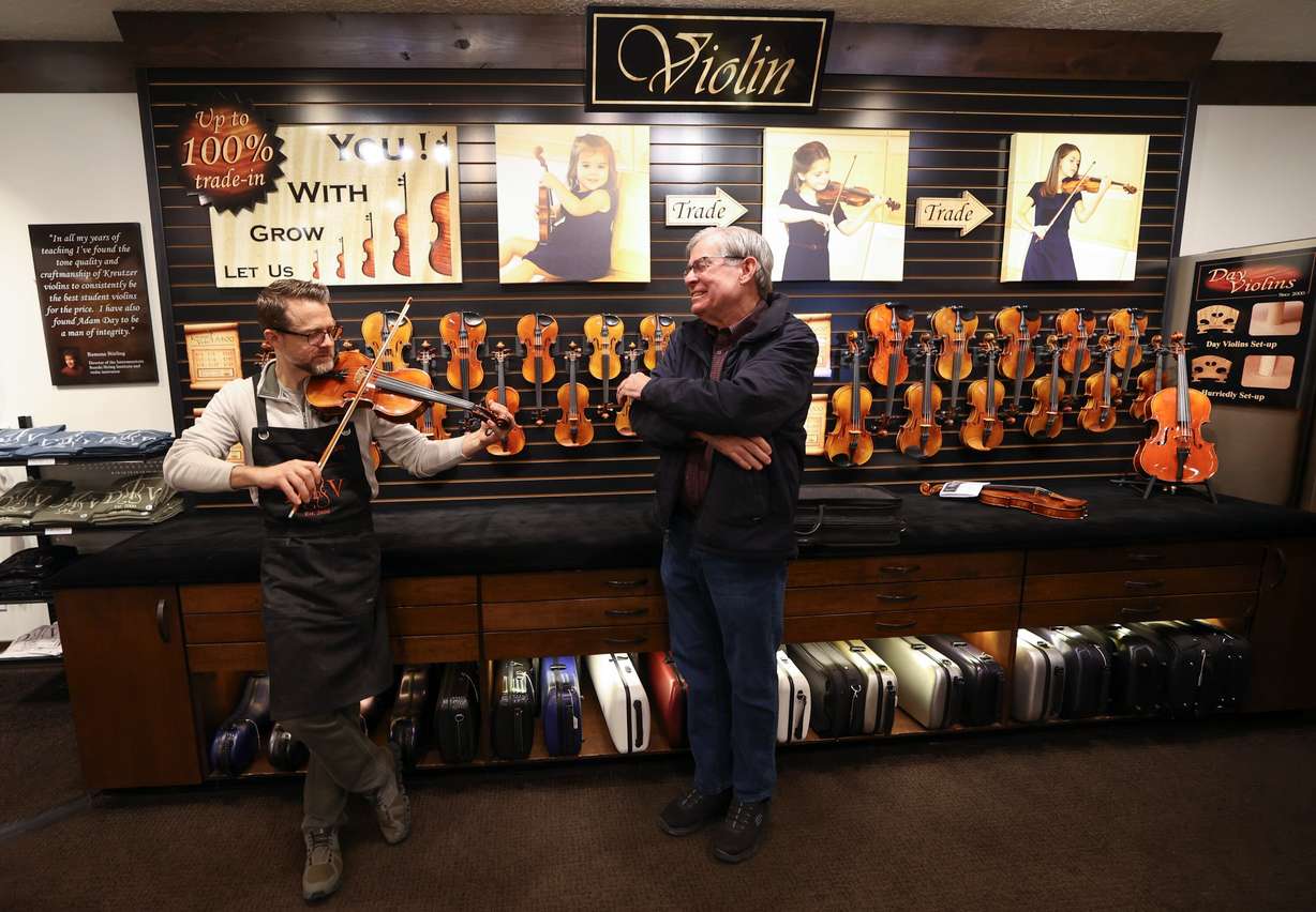 Adam Day, Day Violins owner, diagnoses sound quality issues on a violin Chris Robison brought in for his daughter at Day Violins in Murray on March 20.