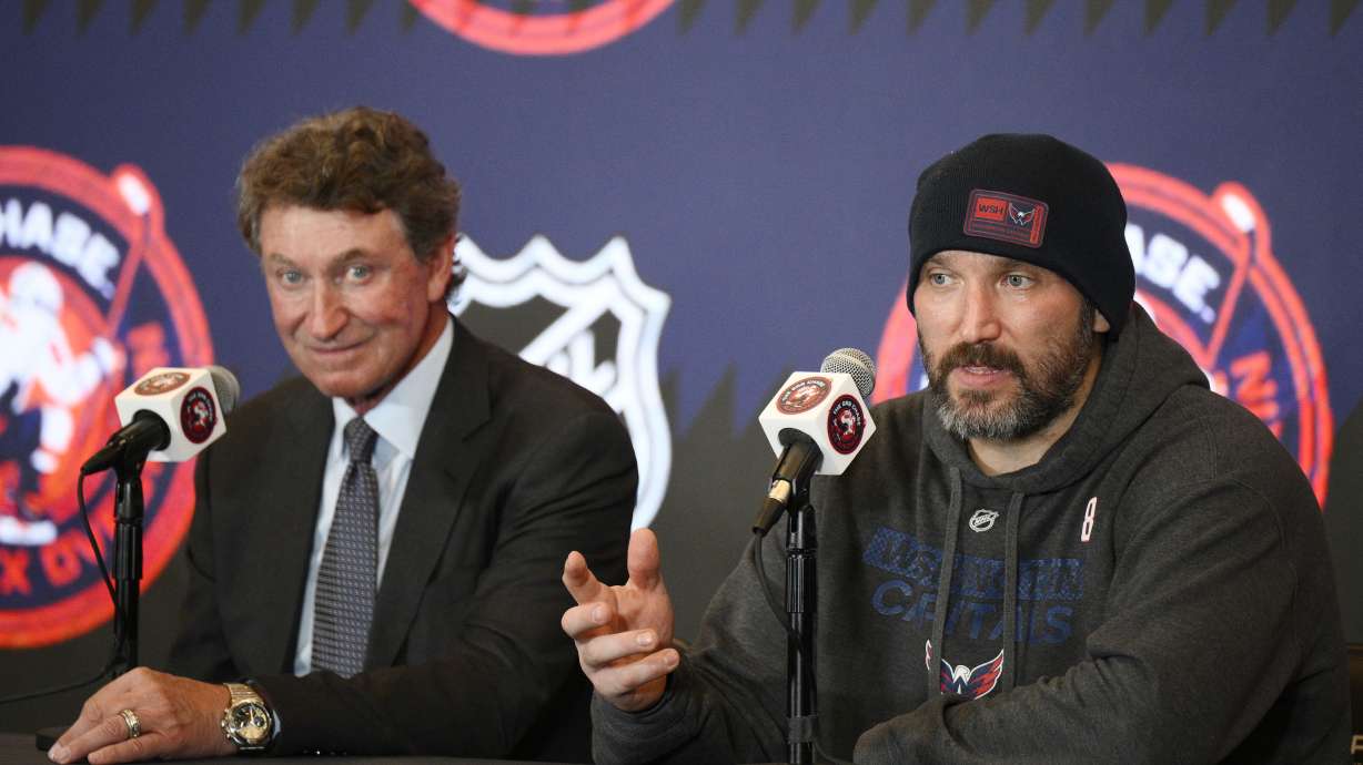 Former NHL player Wayne Gretzky, left, with Washington Capitals Alex Ovechkin, right, during a press conference after an NHL hockey game in which Ovechkin tied Gretzky's NHL career goals record of 894th goals, Friday, April 4, 2025, in Washington.