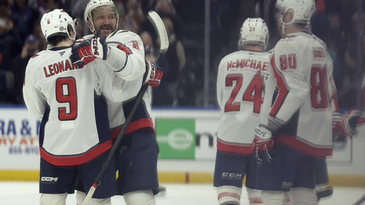 Washington Capitals left wing Alex Ovechkin (8), second left, celebrates after scoring his 895th career goal during the second period of an NHL hockey game against New York Islanders in Elmont, N.Y., Sunday, April 6, 2025.