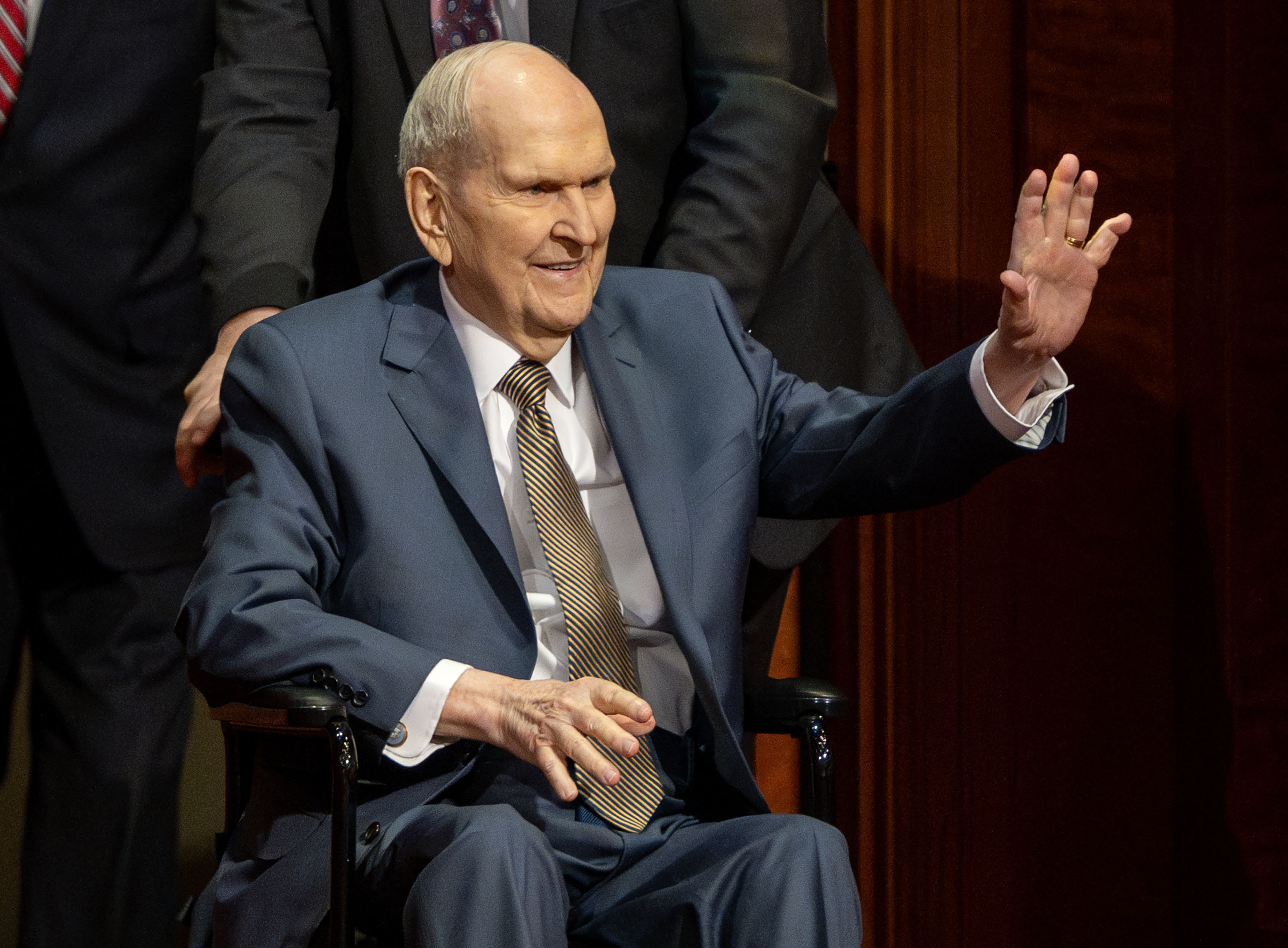 President Russell M. Nelson waves as he enters the afternoon session of general conference at the Conference Center in Salt Lake City on April 6. The president of The Church of Jesus Christ of Latter-day Saints died Saturday at age 101.