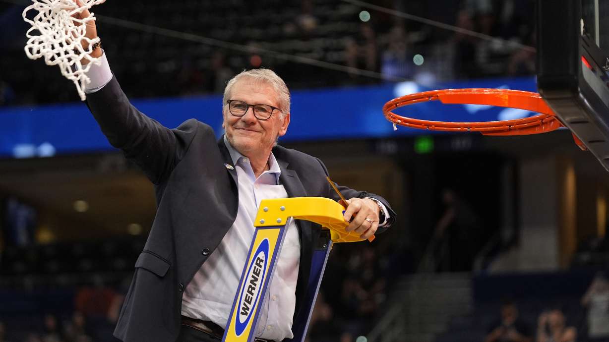 UConn head coach Geno Auriemma holds up the net after defeating South Carolina in the national championship game at the Final Four of the women's NCAA college basketball tournament, Sunday, April 6, 2025, in Tampa, Fla.