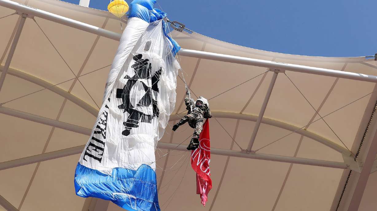 A parachutist became snagged on the roof of a stadium in France after the pre-match ceremony went wrong on Sunday.