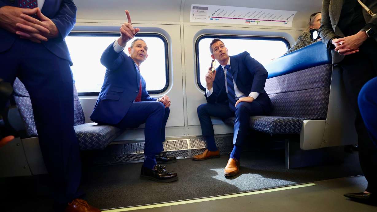 U.S. Secretary of Transportation Sean Duffy, right, talks with Sen. John Curtis, R-Utah, on the FrontRunner in Salt Lake City on Monday. The two met to discuss Utah’s approach to streamlining projects.