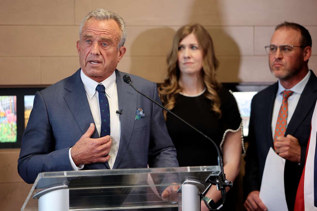 U.S. Department of Health and Human Services Secretary Robert F. Kennedy Jr. speaks in Salt Lake City on April 7. Rep. Stephanie Gricius, R-Eagle Mountain, HB81 bill sponsor, and House Speaker Mike Schultz, R-Hooper, listen.