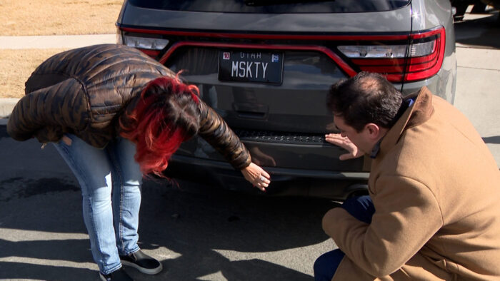 Andrea Olsen, left, shows KSL's Matt Gephardt damage to her Dodge caused when another driver rear-ended her.