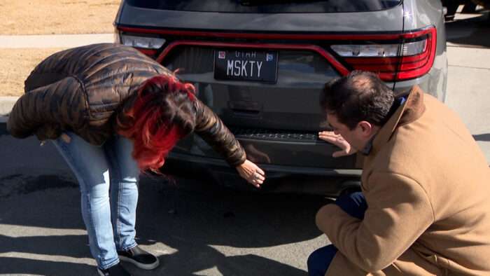 Andrea Olsen, left, shows KSL's Matt Gephardt damage to her Dodge caused when another driver rear-ended her.