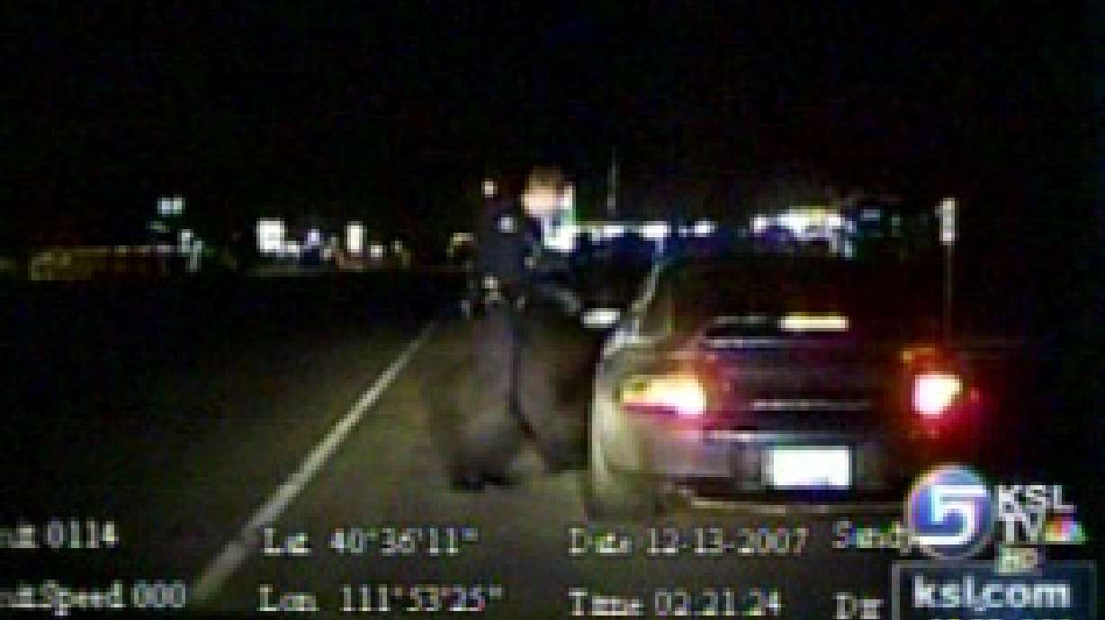 Motorist drives off with officer in tow