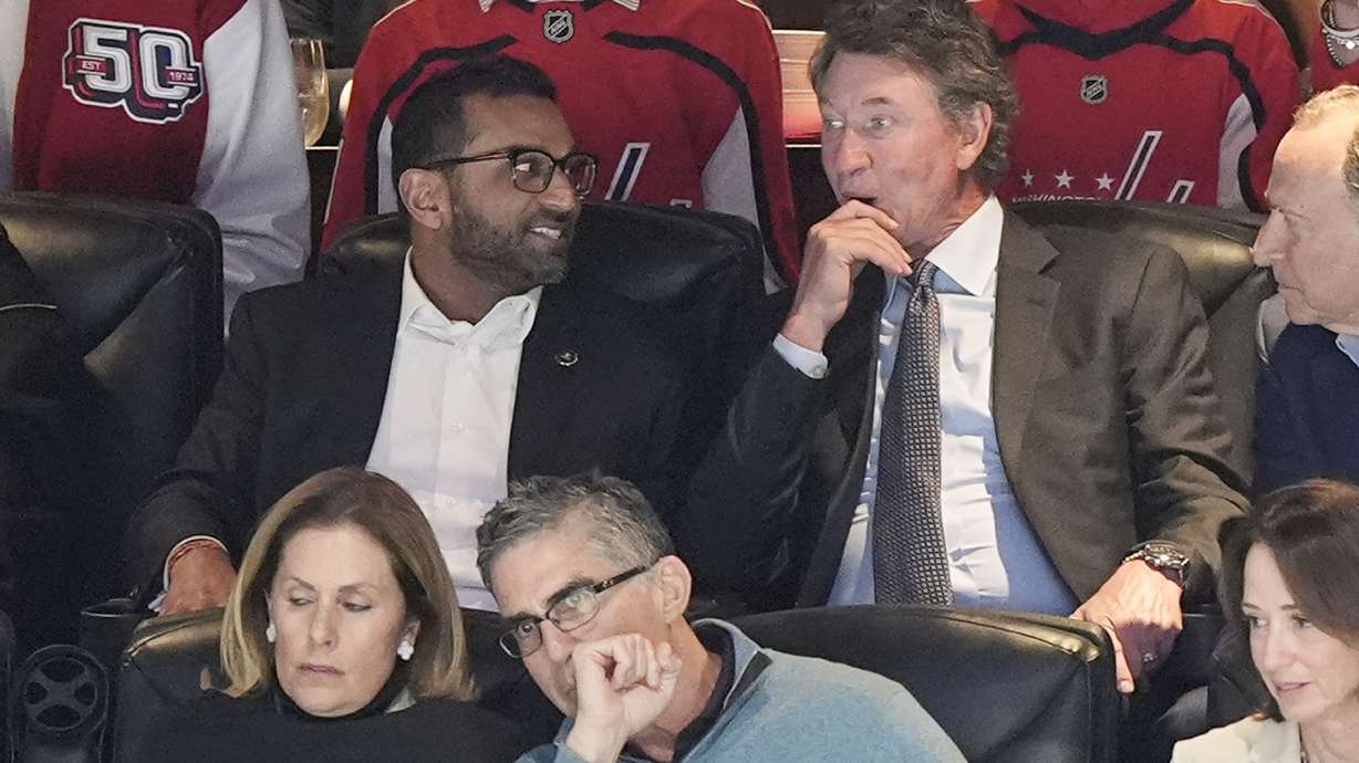 FBI director is Kash Patel, left, tallking with former NHL player Wayne Gretzky, right, during the first period of an NHL hockey game between the Washington Capitals and Chicago Blackhawks, Friday, April 4, 2025, in Washington.
