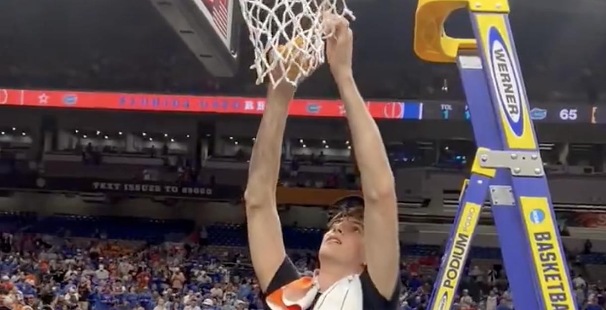 Florida’s 7-foot-9 center Olivier Rioux cuts down the championship net.