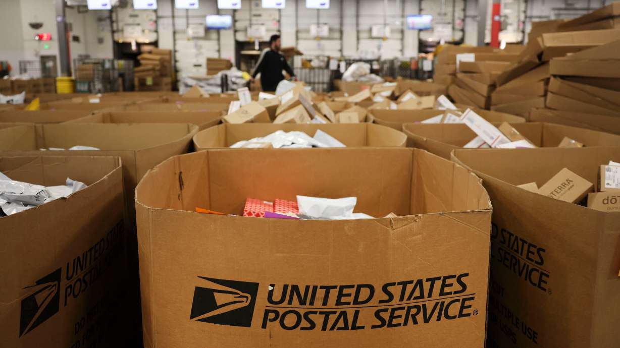 An employee works at the package sorting machine at the United States Postal Service Priority Mail Center in Salt Lake City on Dec. 8, 2022. Utah Sen. Mike Lee is leading efforts in the Senate to ban government workers from engaging in union duties while on the clock.