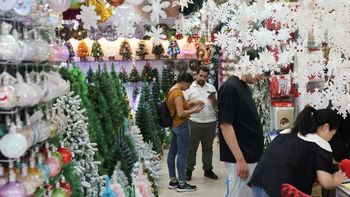 Customers shop for Christmas decorations at a store at Yiwu International Trade Market, in Yiwu, Zhejiang province, China, Wednesday. Christmas decoration orders from China are down amid tariffs issues.
