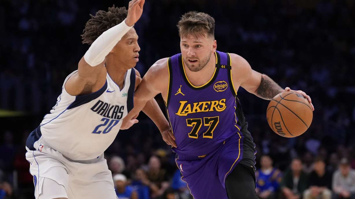 FILE - Los Angeles Lakers guard Luka Doncic, right, moves the ball while defended by Dallas Mavericks forward Kessler Edwards during the first half of an NBA basketball game Tuesday, Feb. 25, 2025, in Los Angeles.