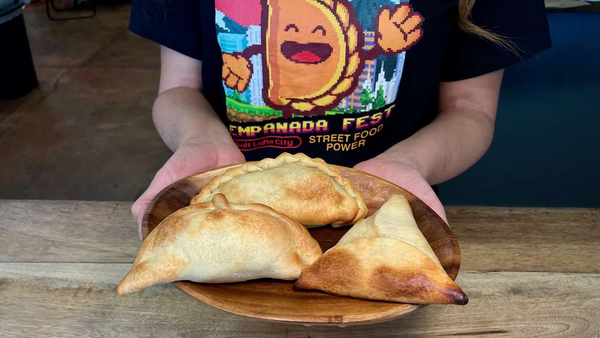 Ana Valdemoros, organizer of Empanada Fest, holds three empanadas at her own locale, Argentina's Best Empanadas in Salt Lake City, on Wednesday.