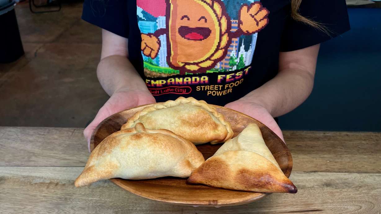 Ana Valdemoros, organizer of Empanada Fest SLC, holds three empanadas at Argentina's Best Empanadas in Salt Lake City, on April 9, 2025. This year's installment of Empanada Fest is set for Saturday.