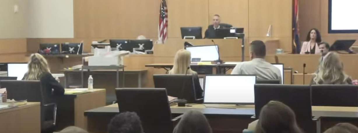 Lori Vallow Daybell sits on the left at her jury trial on Wednesday, while a woman who went on a date with her husband Charles Vallow the day before he was killed, Nancy Jo Hancock, sits on the witness stand.
