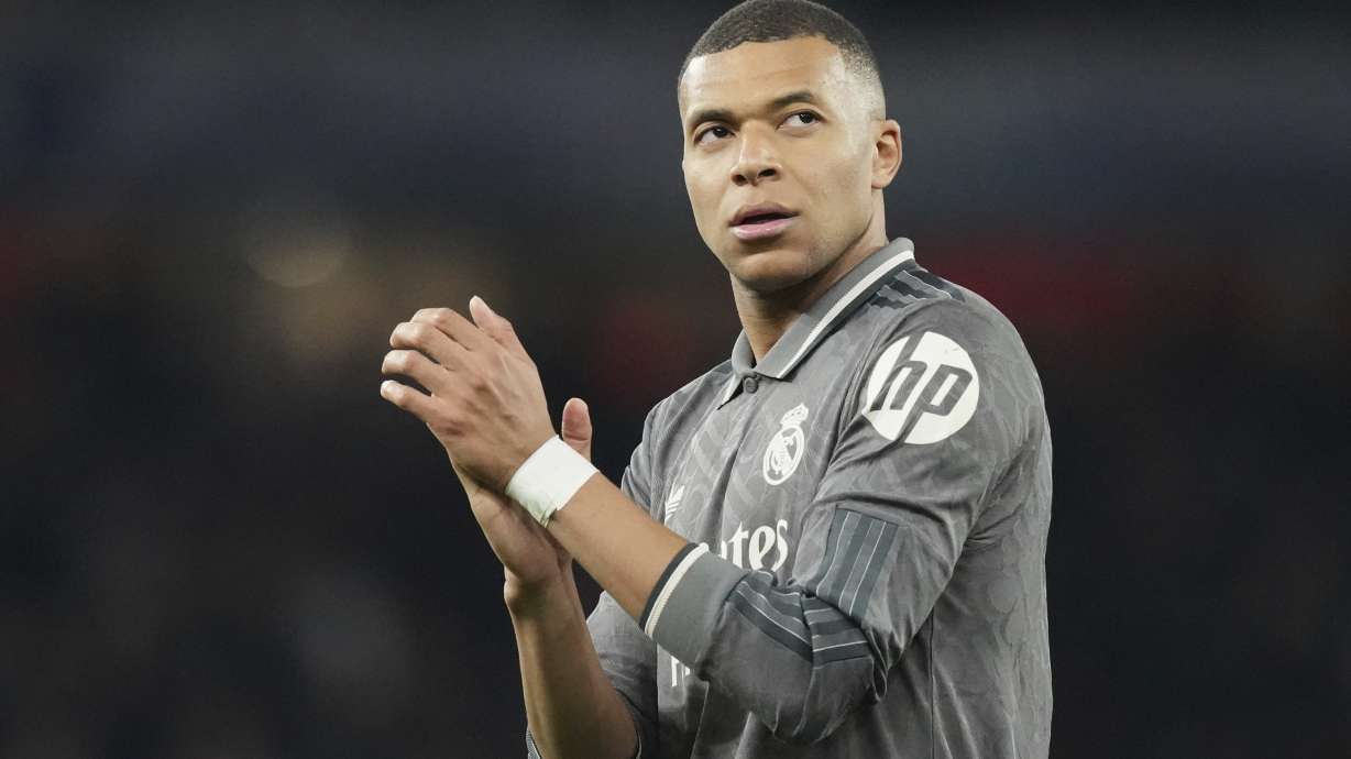 FILE - Real Madrid's Kylian Mbappe applauds fans at the end of the Champions League quarterfinal first leg soccer match between Arsenal and Real Madrid at the Emirates Stadium in London, Tuesday, April 8, 2025. Kylian Mbappé's legal team is going on the attack to try and solve the legal dispute between the World Cup winner and his former club PSG.