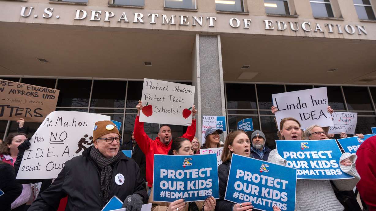 Protesters gather during a demonstration at the headquarters of the Department of Education, March 14, in Washington.