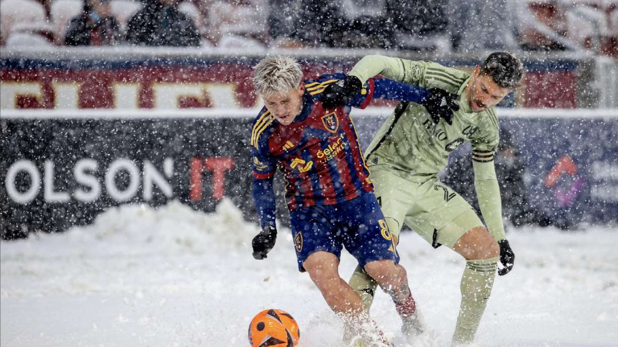 Diego Luna struggles against an LAFC player in the snow at America First Field.