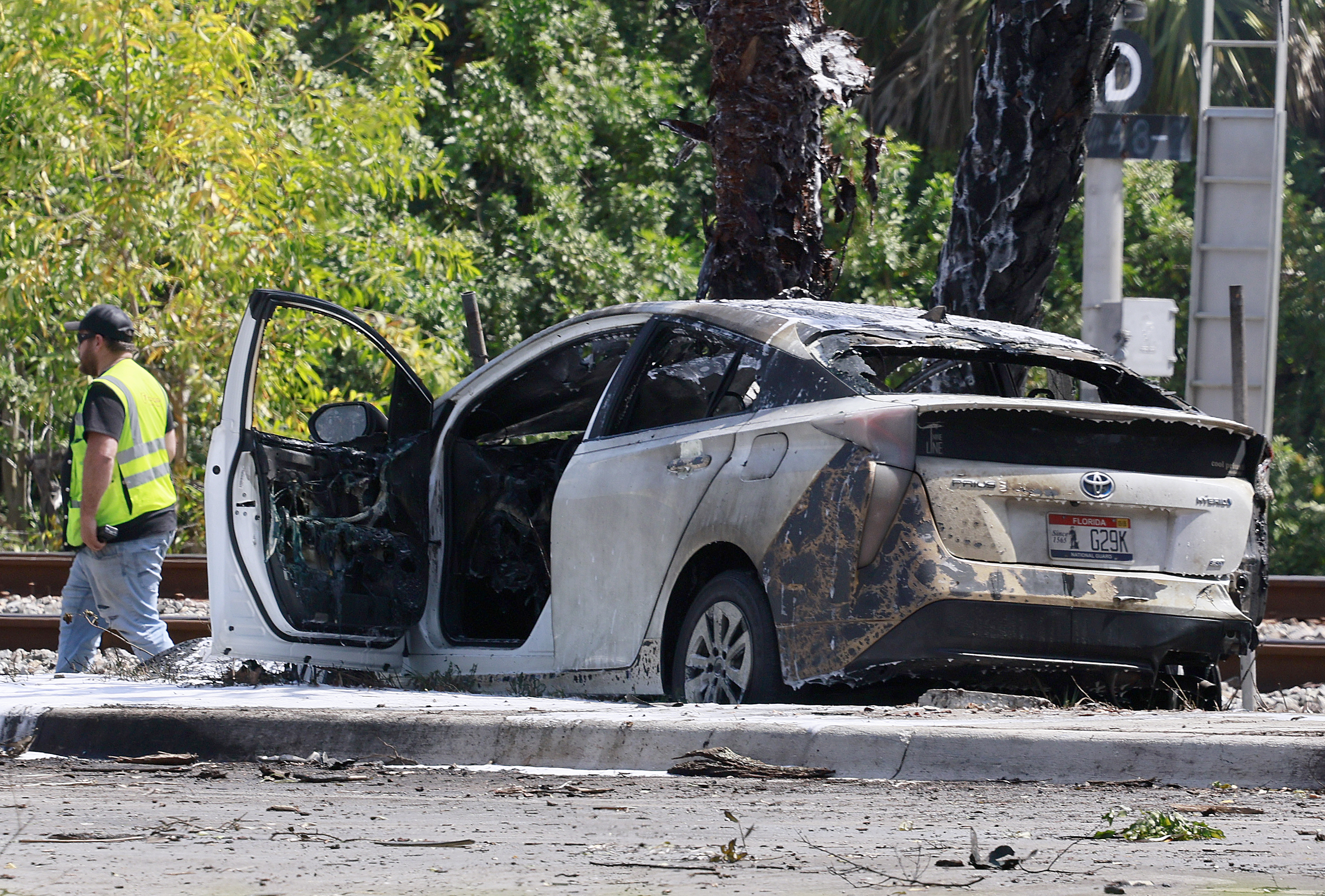 Emergency personnel respond to the area where a small plane crashed on the railroad tracks near Interstate 95 in Boca Raton, Fla., on Friday.