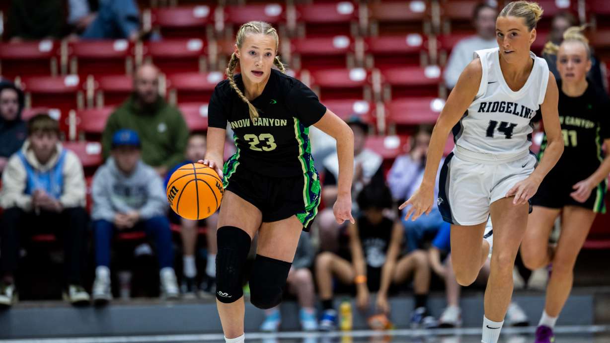 Snow Canyon Warriors guard Olivia Hamlin (23) runs the ball down the court during the finals of the 4A Girls Basketball State Championship against the Ridgeline Riverhawks at America First Event Center in Cedar City on Saturday, Feb. 22, 2025.