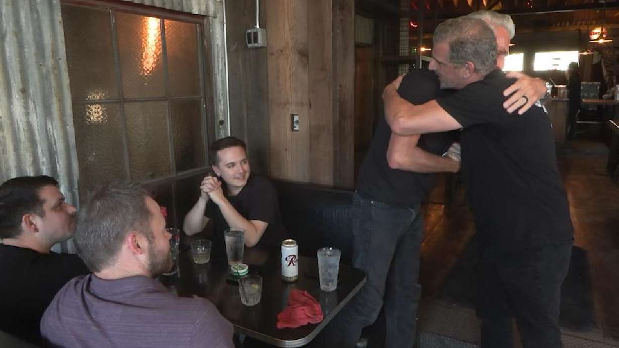 Garage on Beck owner Bob McCarthy hugs a customer who returned for the business's reopening after a fire on June 6, 2024. McCarthy said Thursday that his Salt Lake bar and grill will close for good in May.