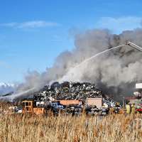 An acre of cars stacked 100 feet tall burns at Salt Lake recycling center
