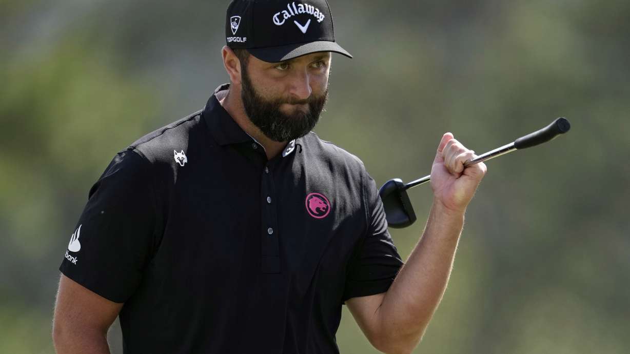Jon Rahm, of Spain, waves after making a putt on the 18th hole during the second round at the Masters golf tournament, Friday, April 11, 2025, in Augusta, Ga.