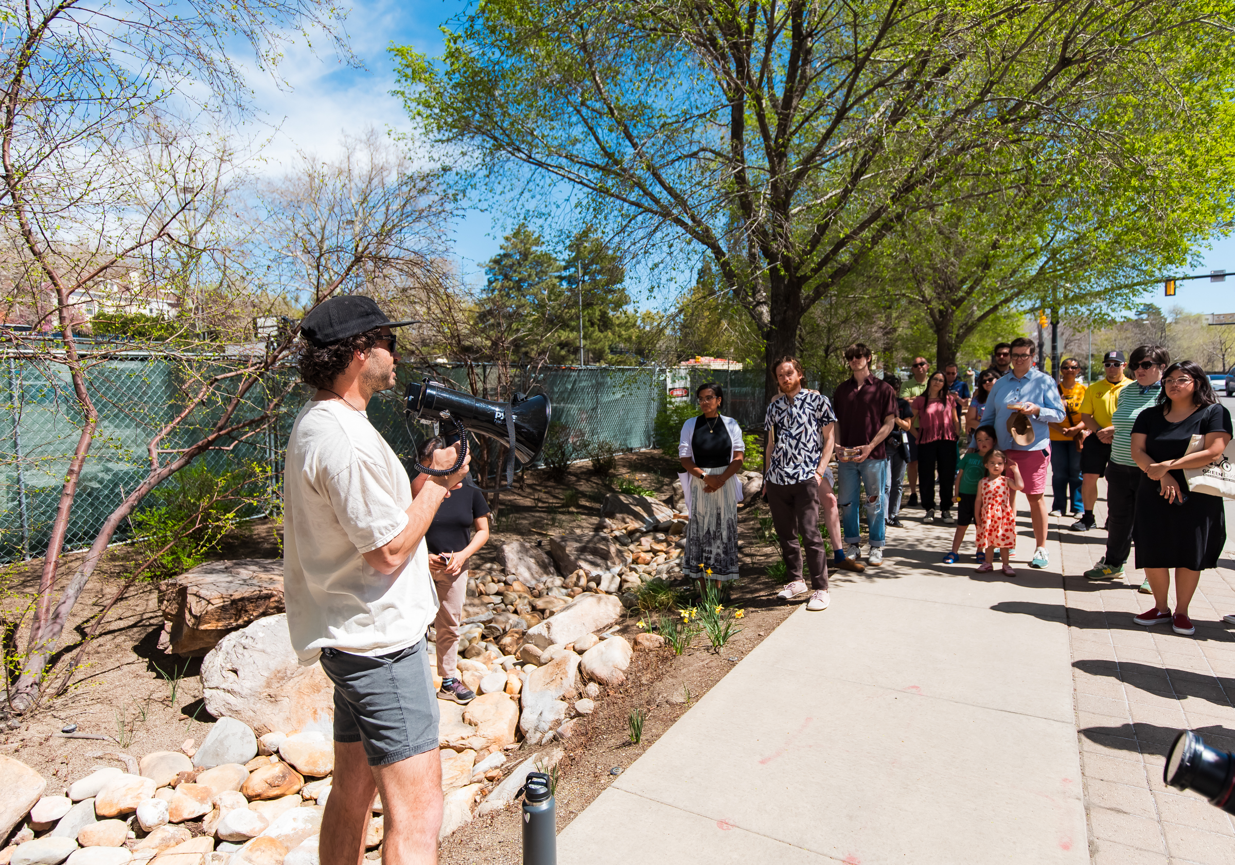 Artist Sawyer Stroud explains his painting to a group of people gathered to view all the "Hidden Waters" art pieces along North Temple in Salt Lake City on Friday.