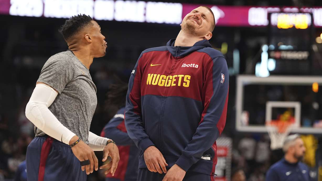 Denver Nuggets guard Russell Westbrook, left, jokes with center Nikola Jokic, right, before an NBA basketball game against the Memphis Grizzlies, Friday, April 11, 2025, in Denver.