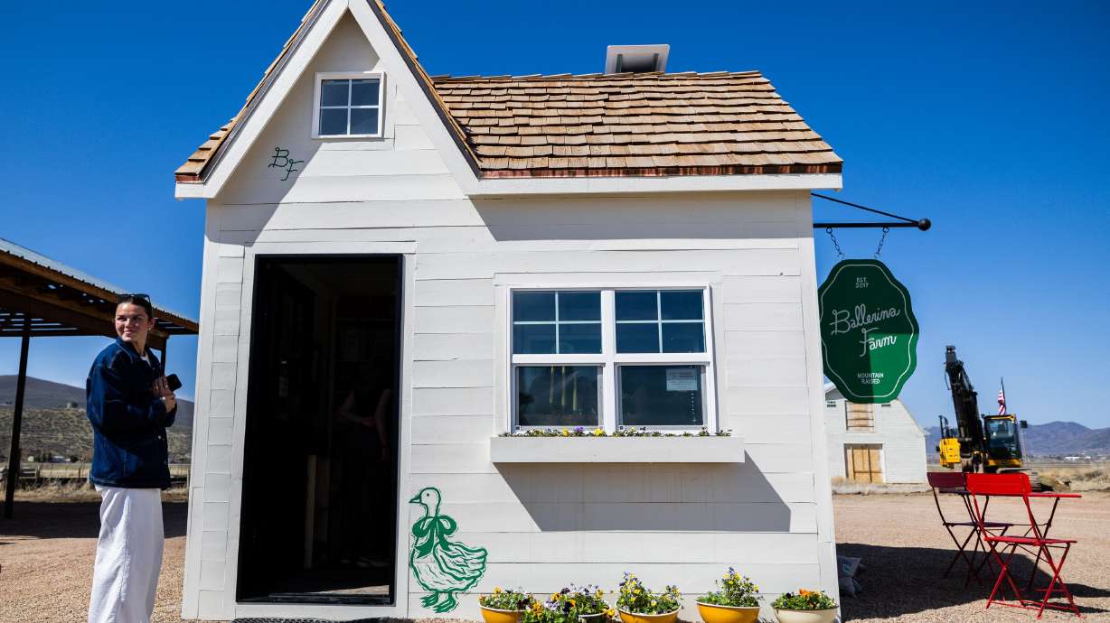 Molly Marquez, from Orem, waits for customers to leave inside so she can enter Ballerina Farm’s new farm stand in Kamas on Thursday, April 11.
