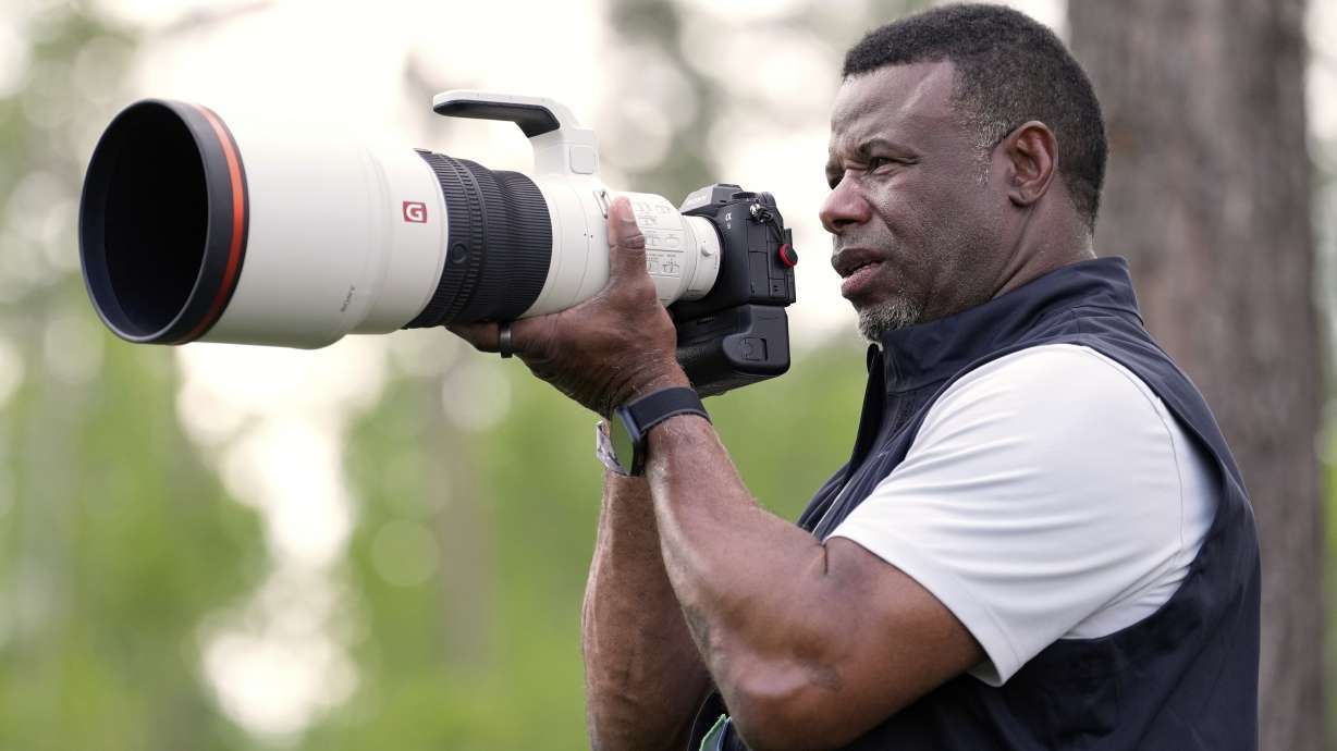 Former MLB great Ken Griffey Jr. takes photos on the 12th hole during the second round at the Masters golf tournament, Friday, April 11, 2025, in Augusta, Ga.