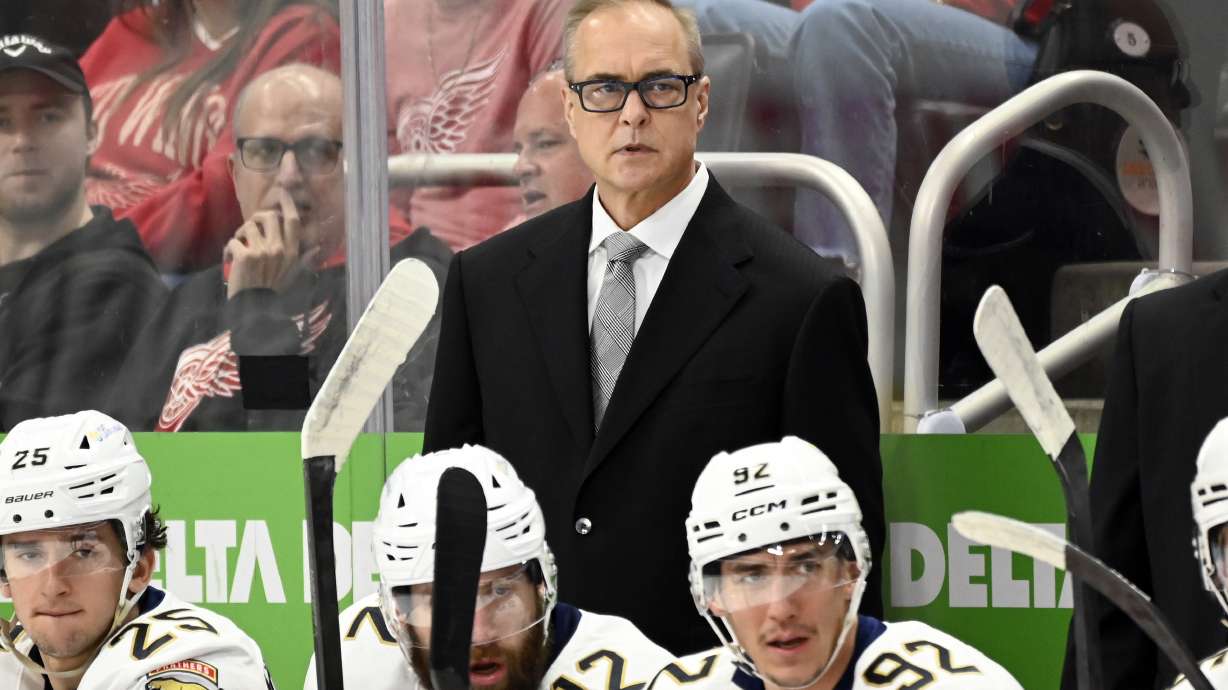 Florida Panthers head coach Paul Maurice, standing, watches during the first period of an NHL hockey game against the Detroit Red Wings, Sunday, April 6, 2025, in Detroit.