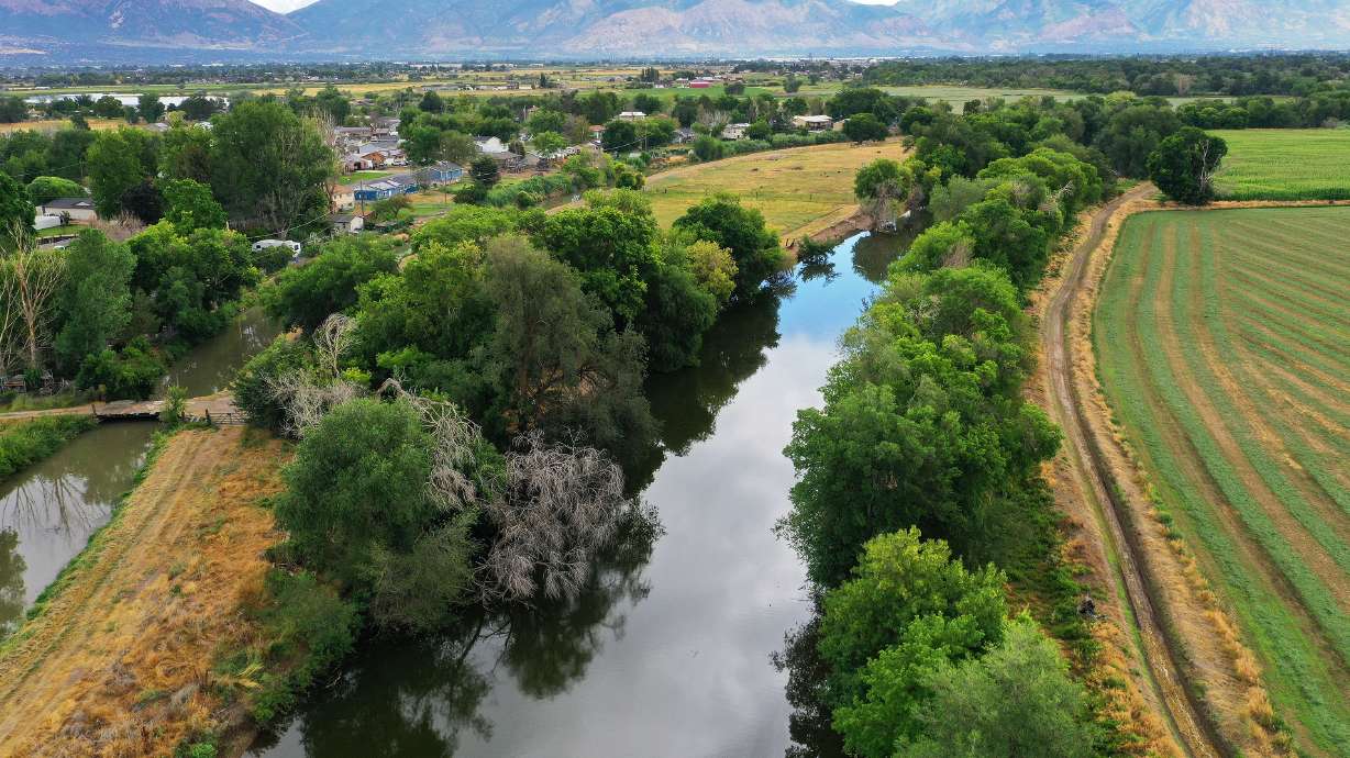 The Weber River and Warren Canal wind through Weber County on July 26, 2023. The owner of a construction material recycling center was charged Friday with two counts of unlawful discharge of pollutants, a third-degree felony.