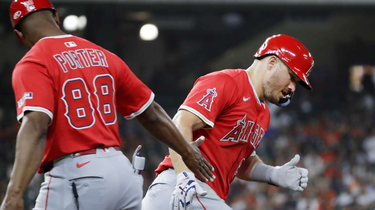 Los Angeles Angels' Mike Trout, right, celebrates after his home run with first base coach Bo Porter (88) as he rounds the bases against the Houston Astros during the fourth inning of a baseball game Friday, April 11, 2025, in Houston.