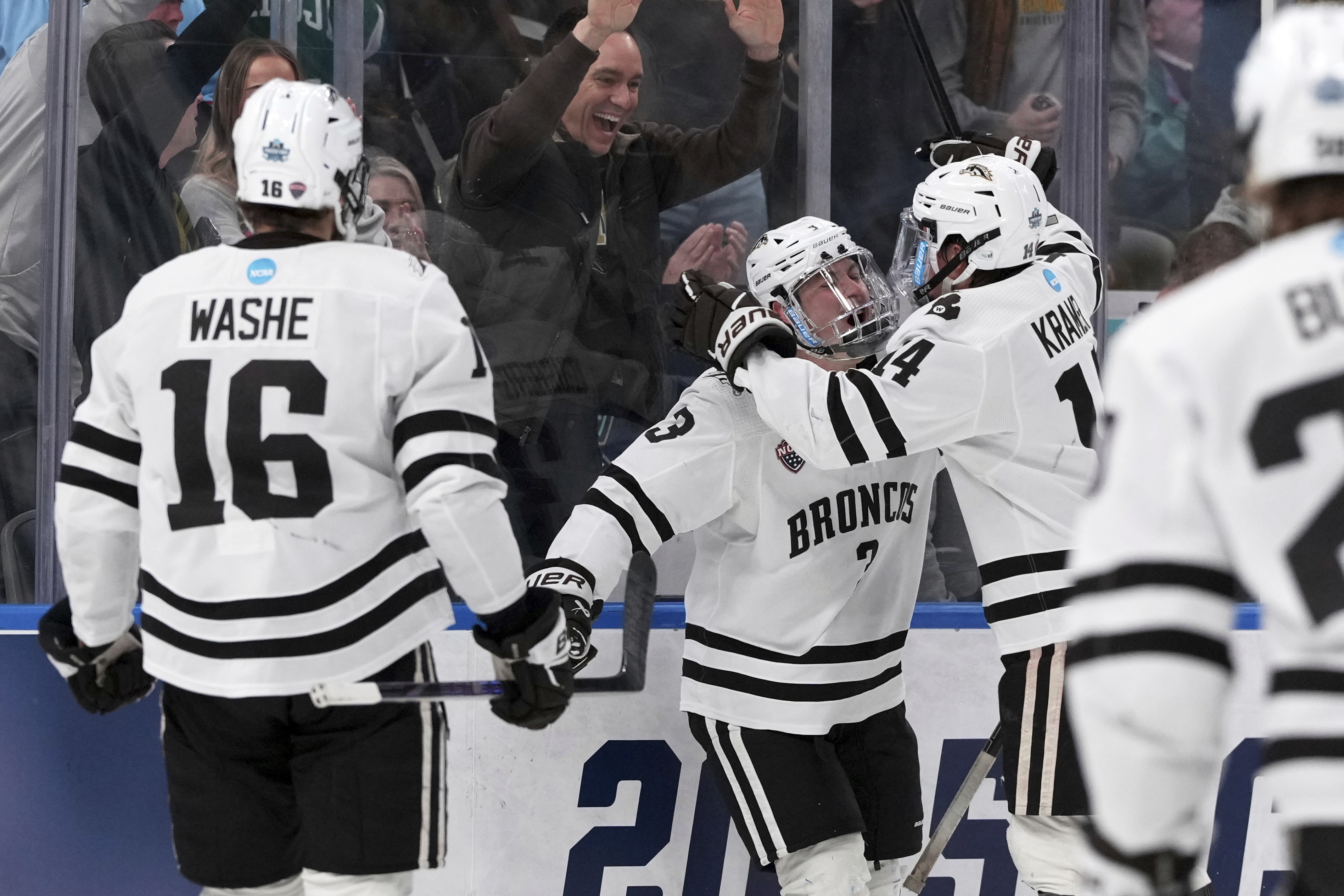 Western Michigan's Cole Crusberg-Roseen (3) is congratulated by Brian Kramer and Tim Washe (16) after scoring during the first period in the championship game of the NCAA Frozen Four men's college hockey tournament against the Boston University, Saturday, April 12, 2025, in St. Louis