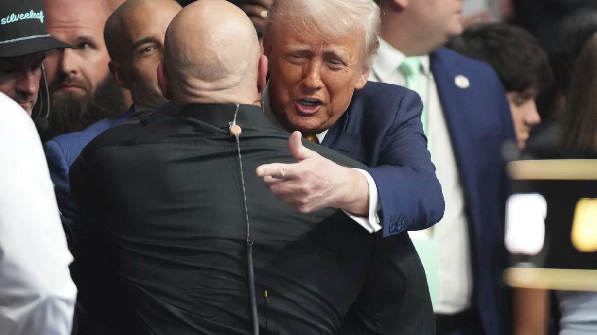 President Donald Trump, right, attends a mixed martial arts fight at UFC 314, Saturday, April 12, 2025, in Miami.