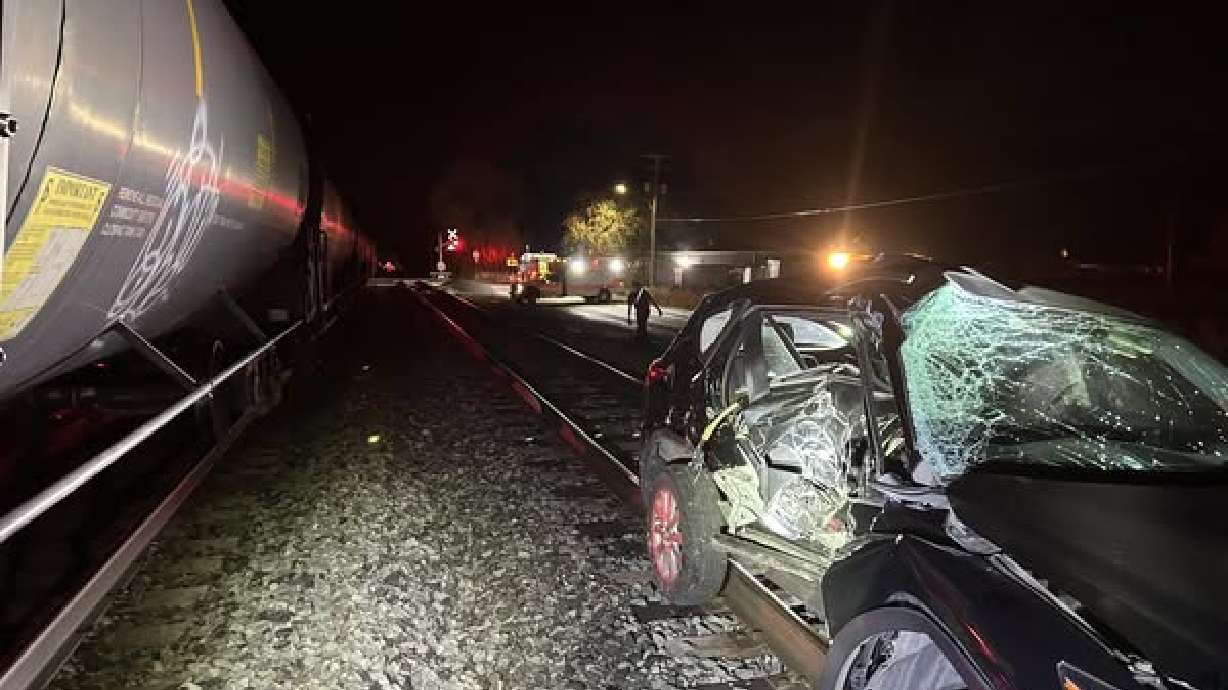 Firefighters said a "citizen hero" helped save a driver whose vehicle became stuck on a railroad truck as a train approached in Springville on Sunday.