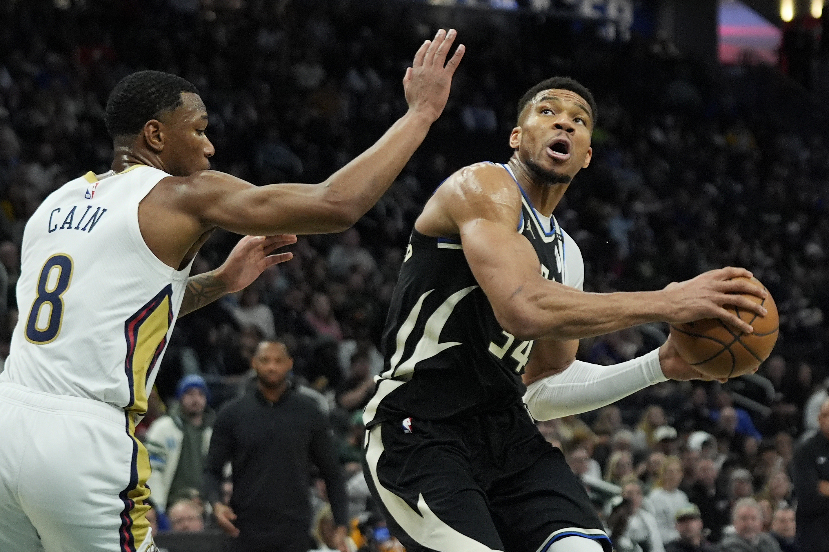 Milwaukee Bucks' Giannis Antetokounmpo, right, drives to the basket against New Orleans Pelicans' Jamal Cain (8) during the first half of an NBA basketball game Thursday, April 10, 2025, in Milwaukee. 