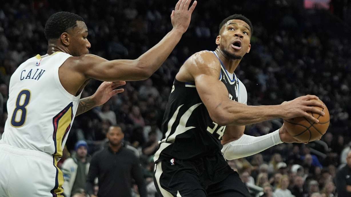 Milwaukee Bucks' Giannis Antetokounmpo, right, drives to the basket against New Orleans Pelicans' Jamal Cain (8) during the first half of an NBA basketball game Thursday, April 10, 2025, in Milwaukee.