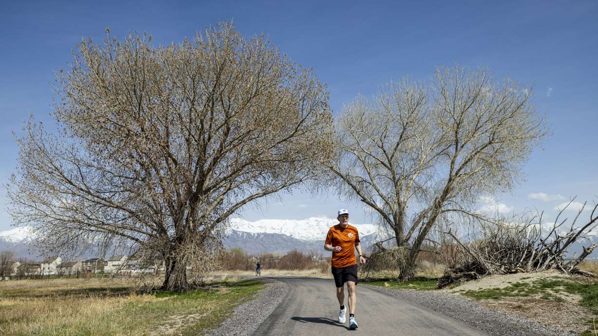 Ultramarathon runner Davy Crockett runs along the Utah Lake Parkway Trail in Saratoga Springs as he trains on Tuesday, April 8.