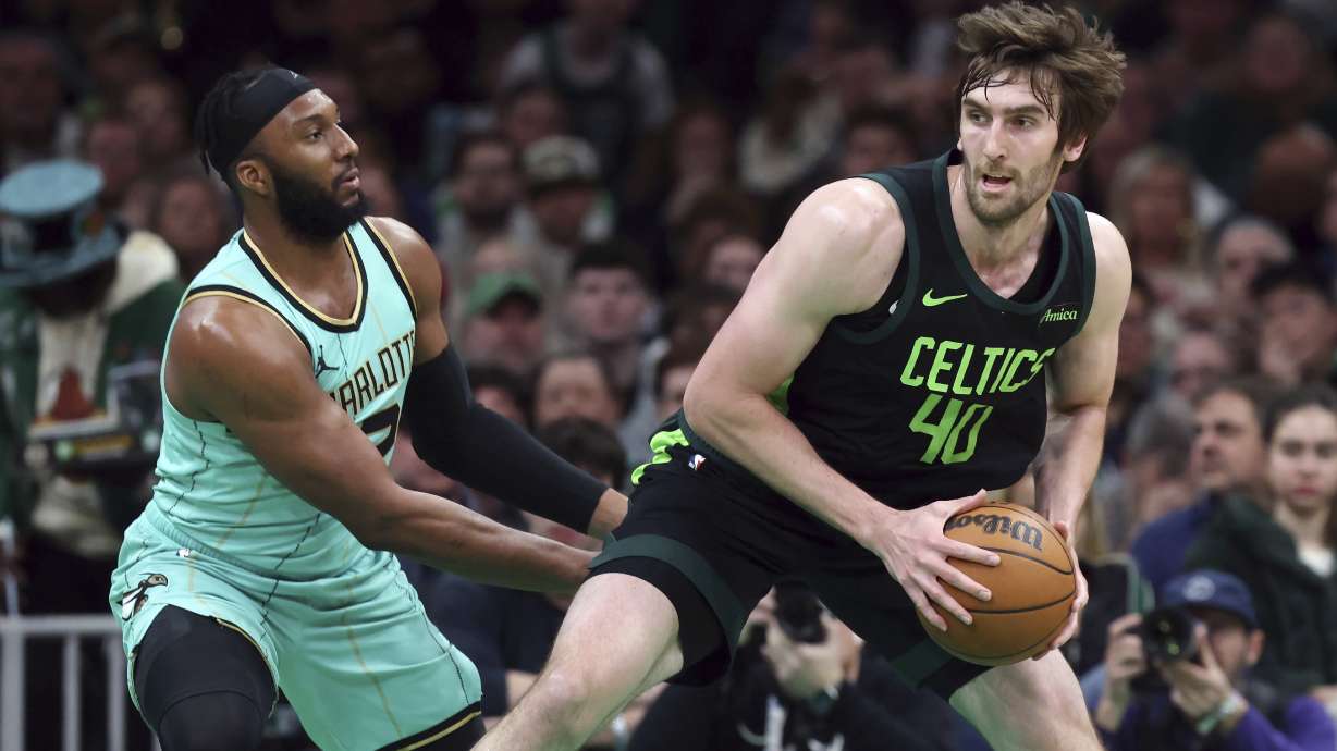 Boston Celtics' Luke Kornet (40) looks to move against Charlotte Hornets' Josh Okogie during the first half of an NBA basketball game Sunday, April 13, 2025, in Boston.