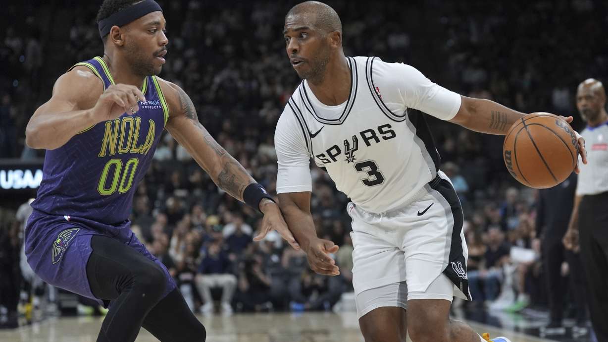 San Antonio Spurs guard Chris Paul (3) drives around New Orleans Pelicans forward Bruce Brown (00) during the first half of an NBA basketball game in San Antonio, Saturday, March 15, 2025.