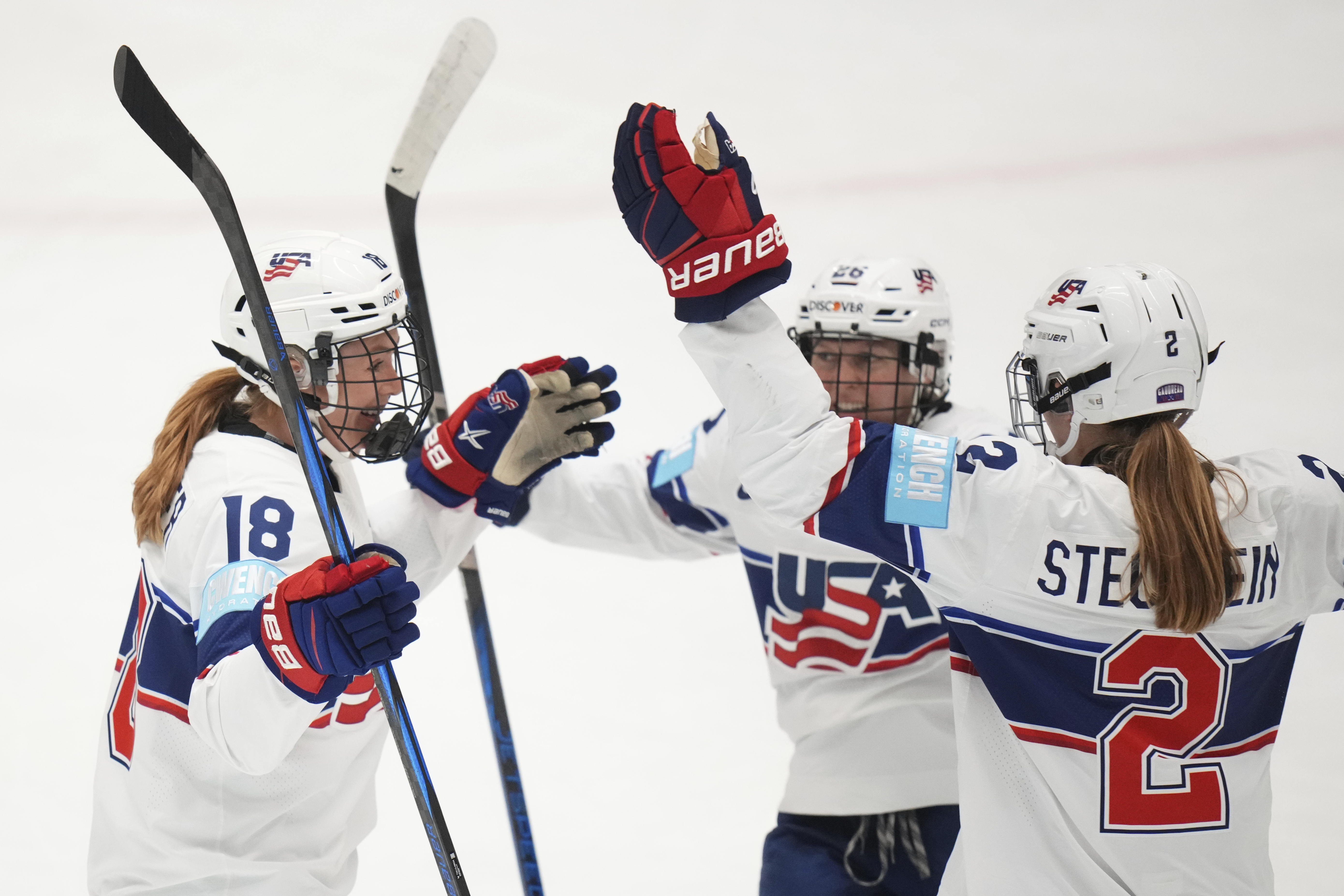 United States' Lee Stecklein, right, celebrates with teammates after scoring her sides first goal during the group A match between United States and Canada at the Women's Ice Hockey Championships in Ceske Budejovice, Czech Republic, Sunday, April 13, 2025. 