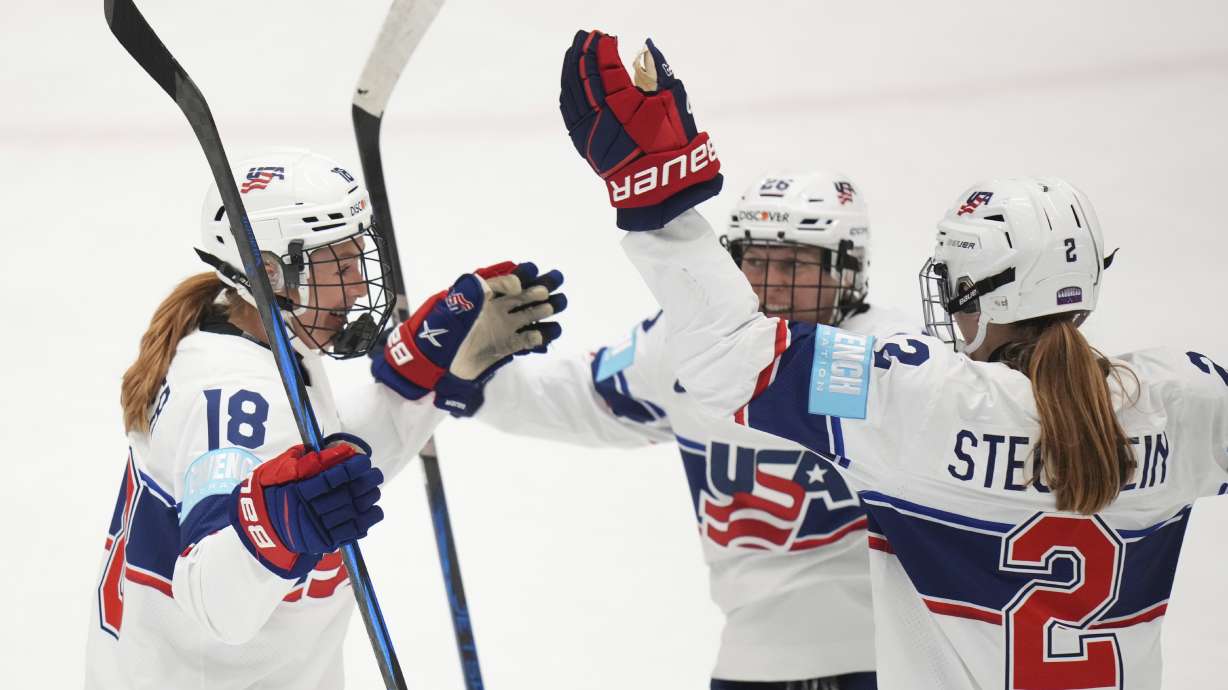 United States' Lee Stecklein, right, celebrates with teammates after scoring her sides first goal during the group A match between United States and Canada at the Women's Ice Hockey Championships in Ceske Budejovice, Czech Republic, Sunday, April 13, 2025.